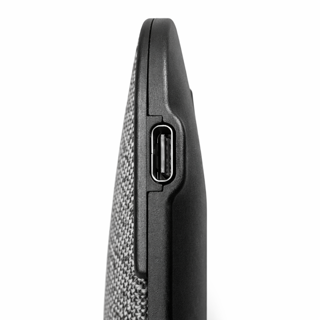 Close‑up of USB‑C charging port on device with fabric and plastic casing.