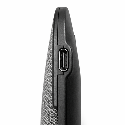 Close‑up of USB‑C charging port on device with fabric and plastic casing.